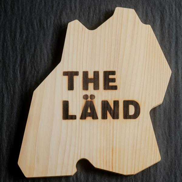 Wooden board in shape of THE LÄND